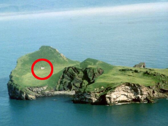 The white house sits alone on the island.