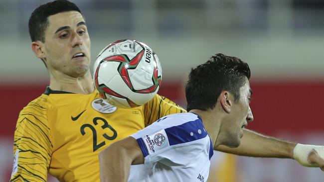 Australia's midfielder Tomas Rogic, left, controls the ball against Uzbekistan's midfielder Odil Ahmedov during the AFC Asian Cup round of 16 soccer match between Australia and Uzbekistan at the Khalifa bin Zayed Stadium in Al Ain, United Arab Emirates, Monday, Jan. 21, 2019. (AP Photo/Kamran Jebreili)