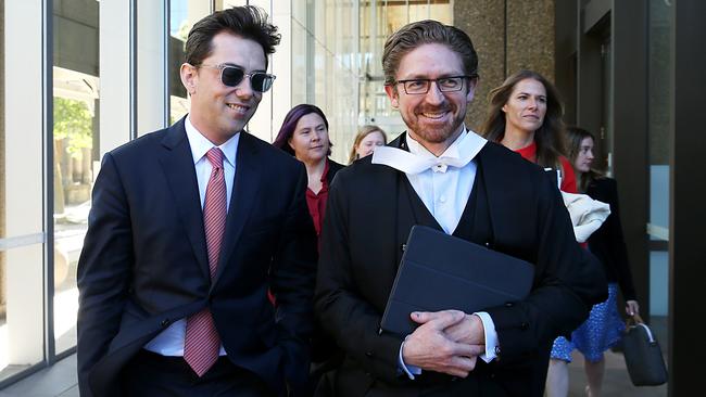 Joe Aston leaving Federal court with his lawyer in the defamation trial against Elaine Stead. Picture: Jane Dempster.