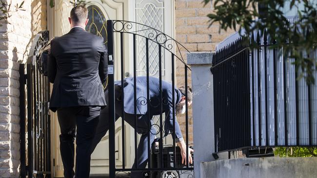 Mr Moselmane’s Rockdale home being raided by the AFP on Friday. Picture: Dylan Robinson