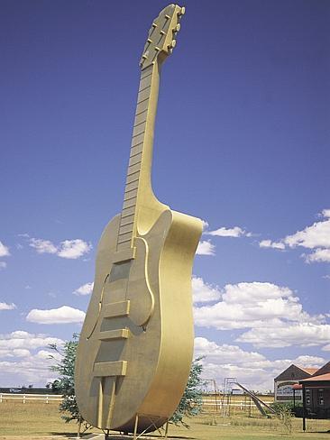 Kasey Chambers always has a photo taken at the Big Golden Guitar outside Tamworth. Picture: Tourism NSW.