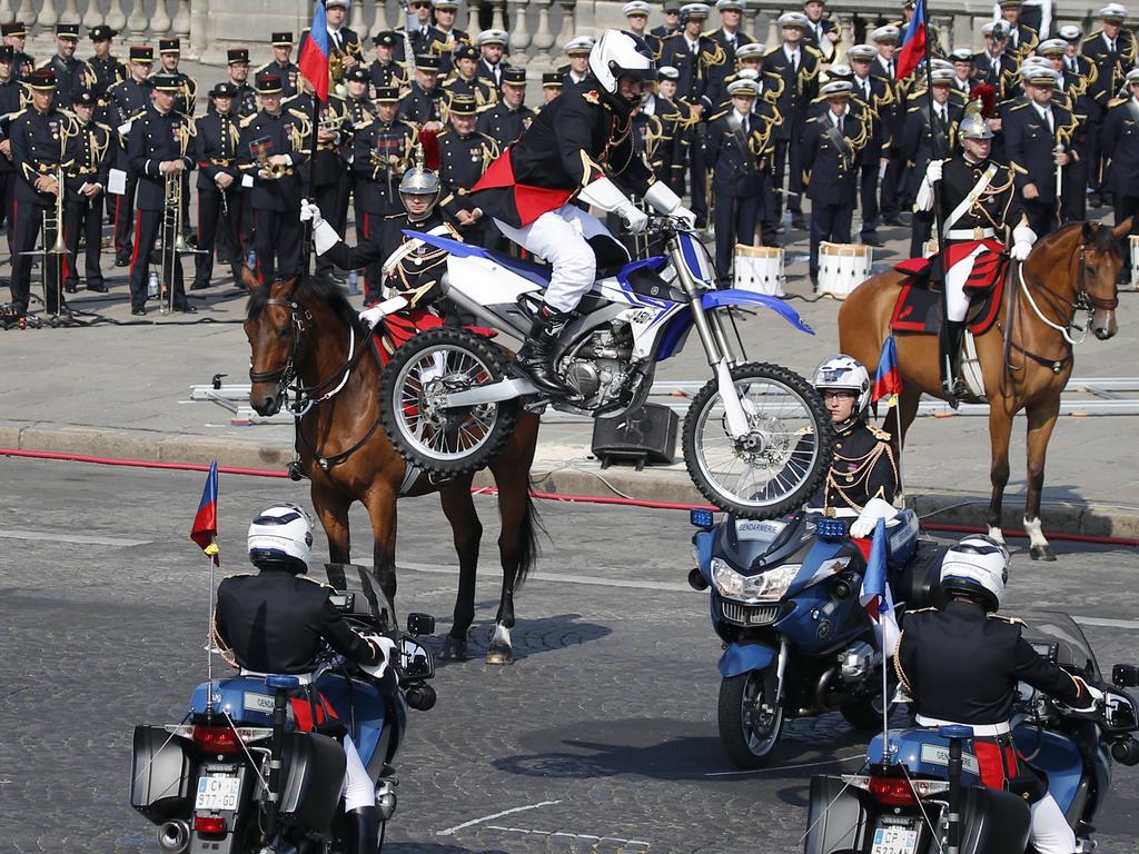 Members of the French Republican Guard perform a demonstration as part of the Bastille Day parade on the Champs Elysees avenue in Paris, France, Saturday, July 14, 2018. France's military is marching through Paris for Bastille Day celebrations and getting a budget boost from President Emmanuel Macron. (AP Photo/Francois Mori)