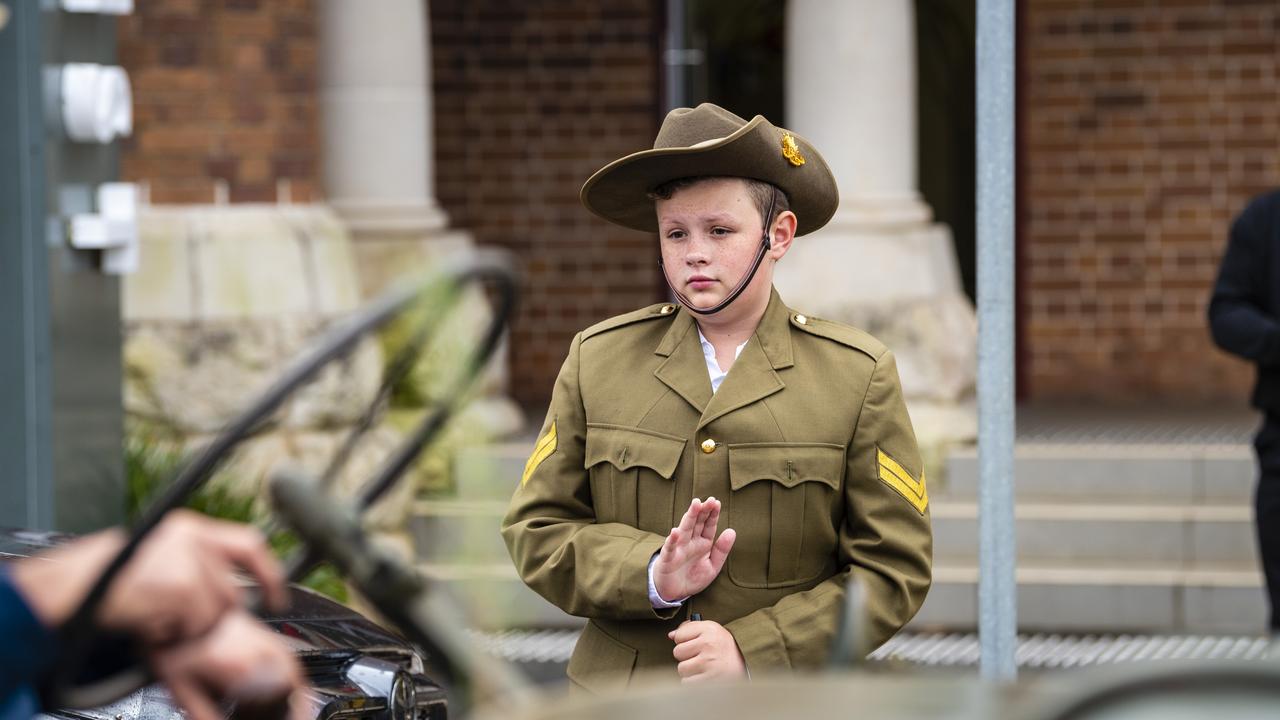 Koby Creighton pays his respect to the veterans marching in the Anzac Day morning march, Monday, April 25, 2022. Picture: Kevin Farmer