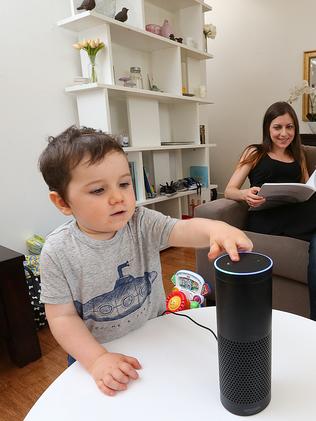 A young boy plays with an Amazon Echo. Picture: Ian Currie