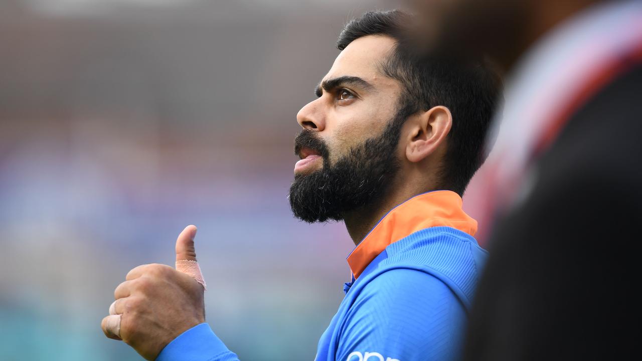 Thumbs up to you too, Virat. (Photo by Adrian DENNIS / AFP)