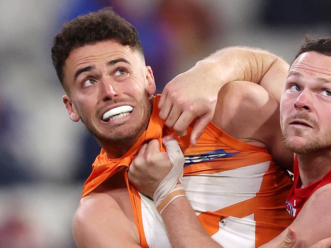 MELBOURNE, JULY 27, 2024: 2024 AFL Football - Round 20 - Melbourne Demons V GWS Giants at the MCG. Steven May of the Demons under pressure from Jake Riccardi of the Giants. Picture: Mark Stewart