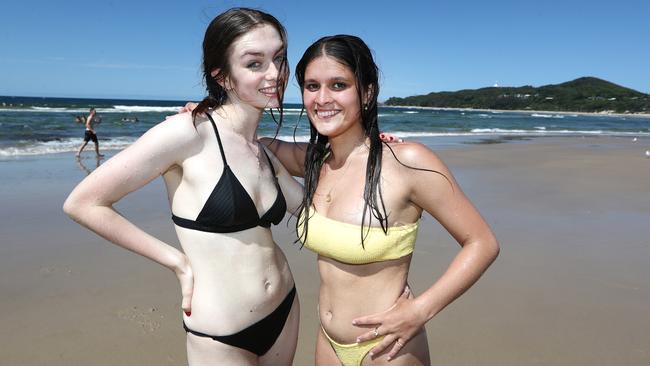 Schoolies Anika Burwood, 17 and Miya Simpson, 18, relax at Clarkes Beach in Byron Bay. Photograph: Jason O'Brien