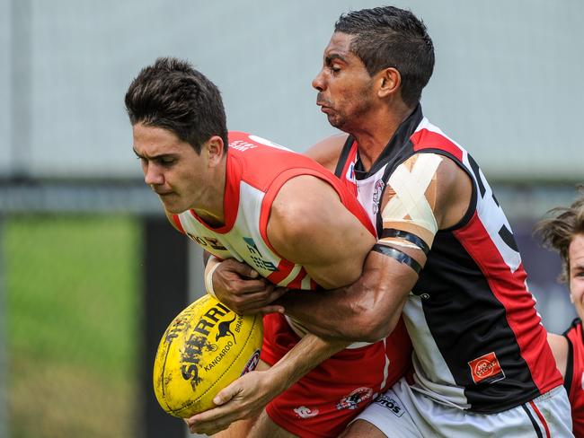 Southern Districts' Charles McAdam tackles Waratah's Brodie Carroll in Sunday's NTFL Premier League match at Gardens Oval.; Picture: FELICITY ELLIOTT