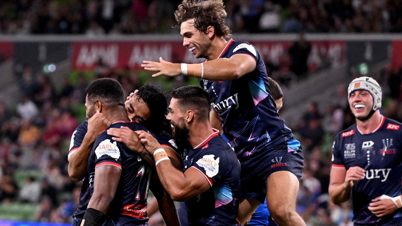 Rebels players celebrate a try scored by Filipo Daugunu (C) during the Super Rugby match between the Melbourne Rebels and the Western Force in Melbourne on March 1, 2024. (Photo by William WEST / AFP) / --IMAGE RESTRICTED TO EDITORIAL USE - STRICTLY NO COMMERCIAL USE--