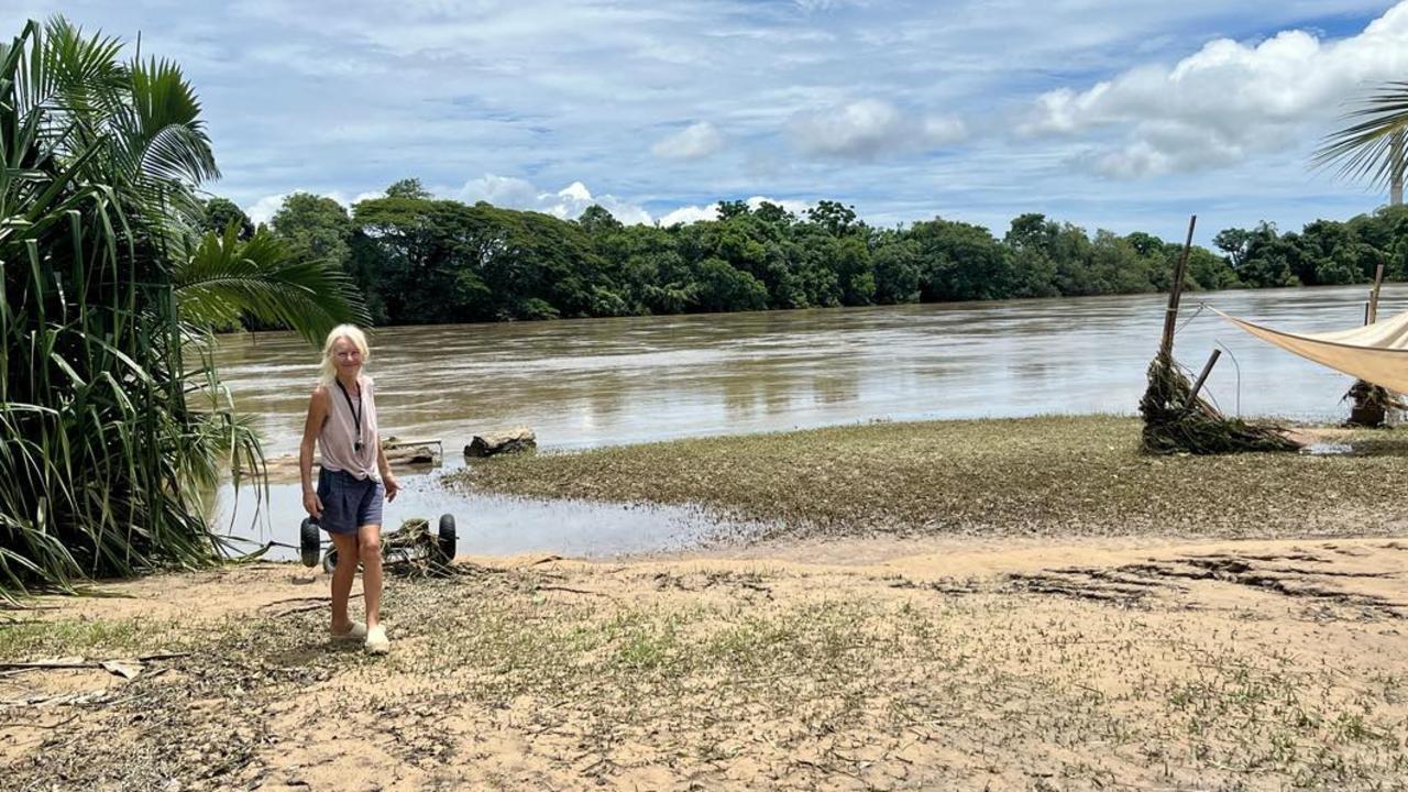 Camille O'Sullivan, a Catholic Education teacher, standing on the banks of the Herbert River outside her flood-ravaged home in Cordelia. Picture: Cameron Bates