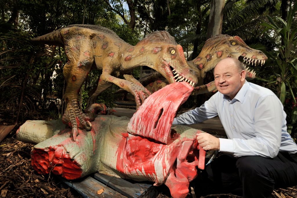 Bill Schoch, general manager at Palmer Coolum Resort, poses with recently delivered model velociraptor dinosaurs that will form part of the resort's new exhibition. Photo: Iain Curry / Sunshine Coast Daily. Picture: Iain Curry