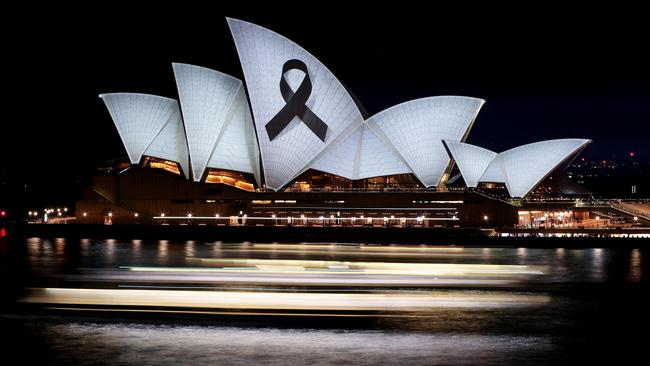 The Sydney Opera House is illuminated with a black ribbon in honour of the victims. Picture: Brendon Thorne/Getty Images