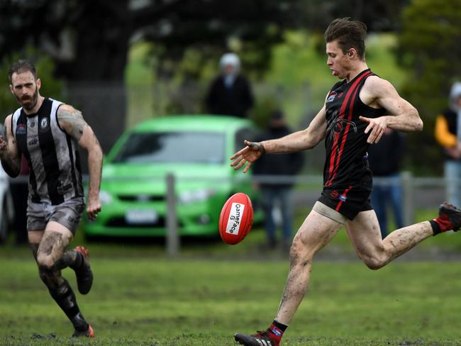 Aaron Holden boots the Redbacks forward.