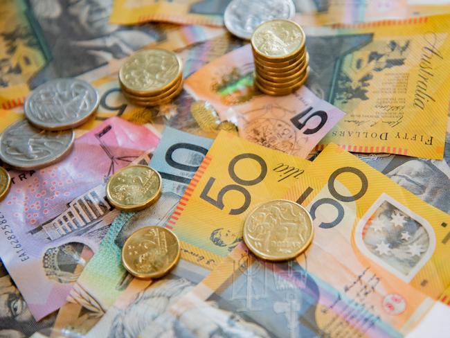 Australian notes and coins spilled out on a table