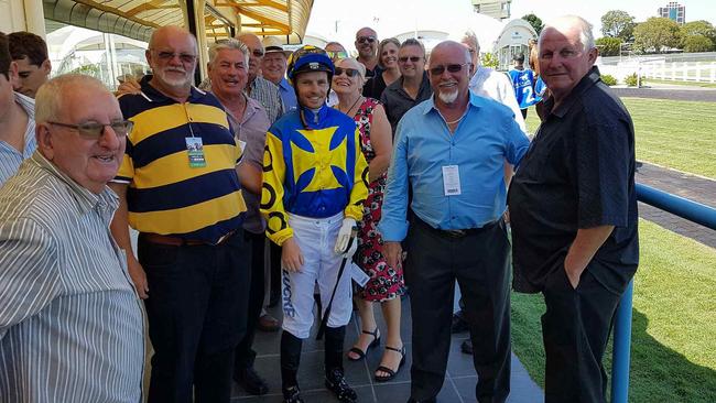 Musgrave Hill Bowls Club player Mike Morgan (navy and yellow strip shirt) with fellow owners and jockey Ryan Wiggins. Picture supplied.