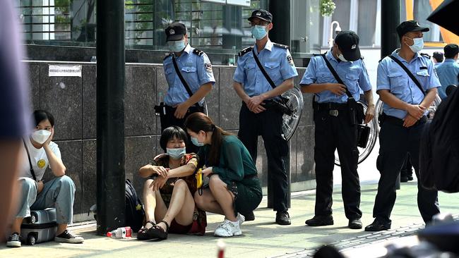 People gather at the Evergrande headquarters building in Shenzhen, southeastern China. Picture: AFP