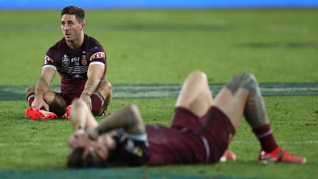 Ben Hunt, left, among the shattered Queensland players. Picture: Getty Images