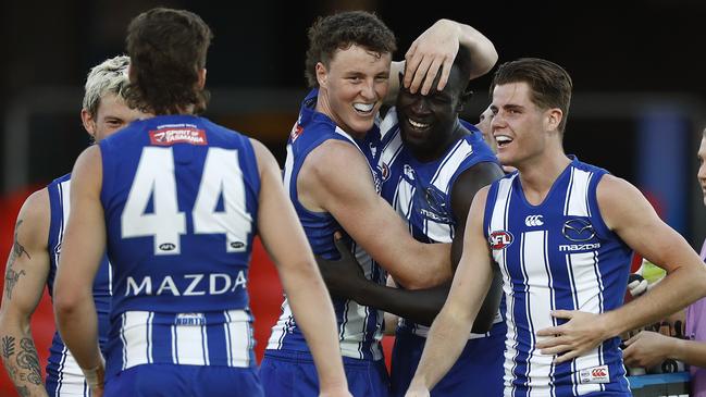 Teammates swamp Majak Daw after kicking a goal in his return game. Picture: Ryan Pierse/Getty Images