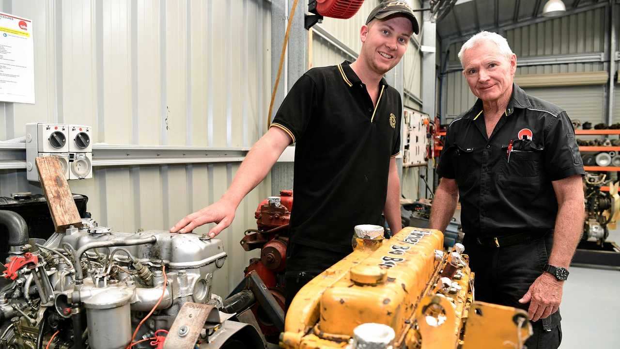 ON THE JOB: First year apprentice Callum McIntosh and Tafe automotive trainer Ian Walsh. Picture: Mike Knott BUN140819TAFE4