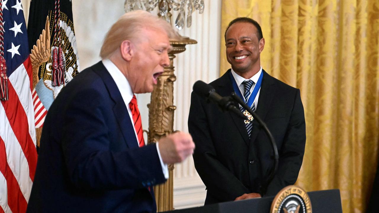 US President Donald Trump speaks alongside US golfer Tiger Woods, during a reception for Black History Month in February. Photo by Jim WATSON / AFP.