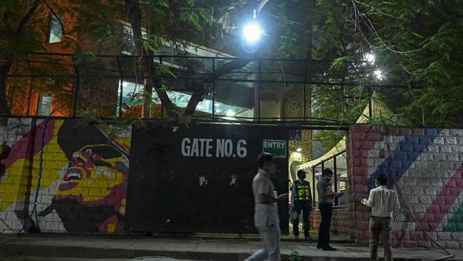 A security guard patrols the ground outside an IPL game, which have been played in front of no fans.