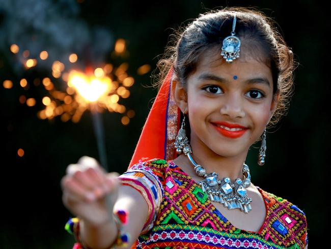 9 year old Neeti Patel poses for photographs wearing her traditional dance attire and holding a sparkler in Wentworthville. Wentworthville, Friday, October 26th 2018. Wentworthville has one of the highest percentages of residents with an Indian background, at 30%, so Diwali (or the Hindu Festival of Lights) is a big deal to them. (AAP Image / Angelo Velardo)