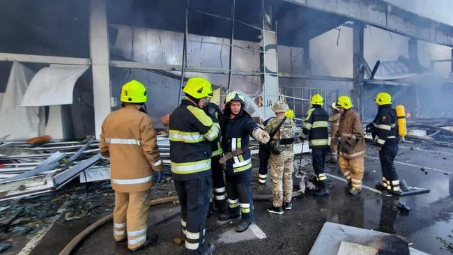 Firefighters putting out the fire in a mall hit by a Russian missile strike in the eastern Ukrainian city of Kremenchuk. Picture: AFP