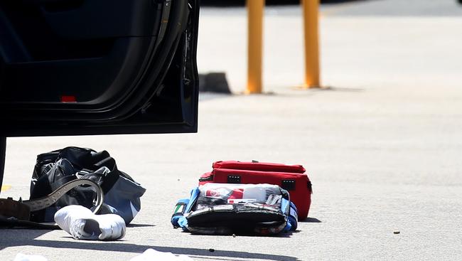 Bullet shells can be seen on the ground outside the car door. Picture: Toby Zerna