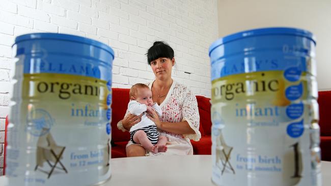 A mum and baby with tins of Bellamy's organic infant formula. (Picture: Troy Snook)