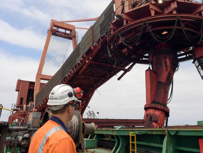 An operations manager watches the ship loader as it loads the Cape Ray with coal at Port Kembla bound for Poland. Are reclaimer is seen in operation (left rear). An ongoing dispute over excessively generous conditions for workers exists at the Port Kembla Coal Terminal.(THE AUSTRALIAN/Simon Bullard)