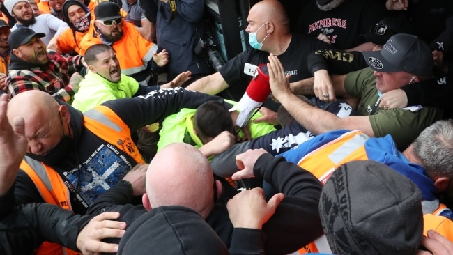 Construction workers protesting against vaccinations gather in front of the CFMEU headquarters in Melbourne on Monday. Picture: David Crosling