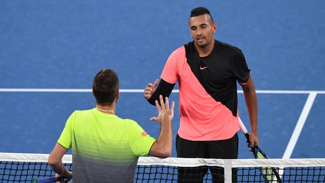 Nick Kyrgios of Australia (above) is congratulated on his win against Viktor Troicki of Serbia (below) during round two on day three of the Australian Open tennis tournament in Melbourne, Wednesday, January 17, 2018.  (AAP Image/Joe Castro) NO ARCHIVING, EDITORIAL USE ONLY