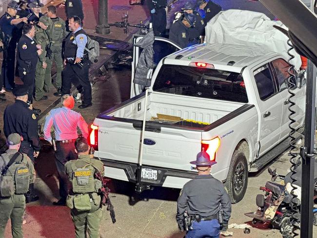 Police and investigators beside the vehicle driven by Shamsud-Din Jabbar in his attack on revellers in New Orleans.