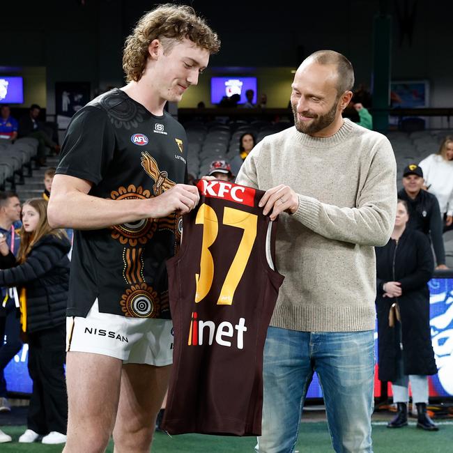 Josh Weddle receives his jumper before his Hawthorn debut.