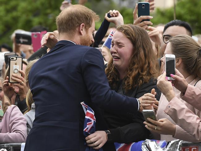 Britain's Prince Harry embraces India Brown in Melbourne. Picture: Pool, William West