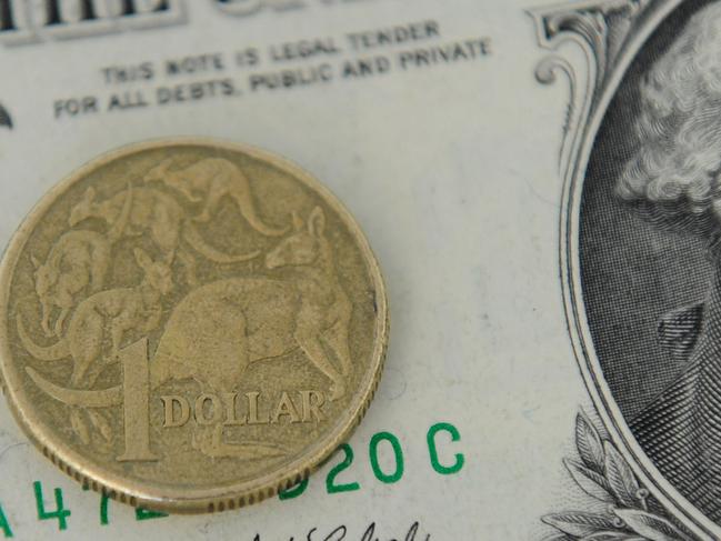 A 1 Australian Dollar coin and a 1 US Dollar note are seen in Canberra, Tuesday, May 21, 2013. As the US economy rebounds, there are predictions that the Australian dollar could fall as low as 90 US cents in the coming weeks and months. (AAP Image/Lukas Coch) NO ARCHIVING