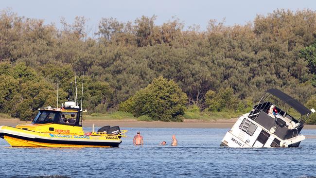 A house boat is stuck on its side in the Broadwater after taking in ...