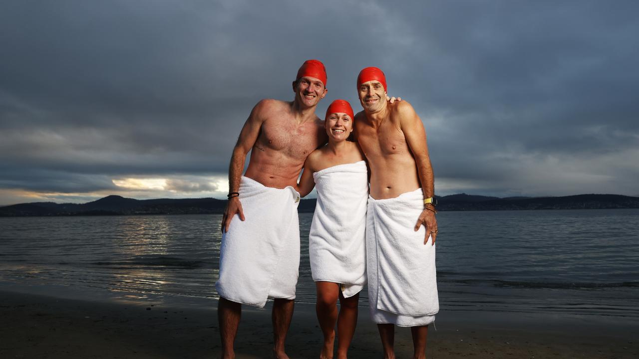 Dave Abrey of Brisbane, Sabrina Carter of Launceston, Glen Harvey of Sydney who became friends after meeting on the beach during the solstice swim one year and now meet up each year to do the swim together. Dark Mofo Nude Solstice Swim 2024 at Long Beach Sandy Bay. Picture: Nikki Davis-Jones