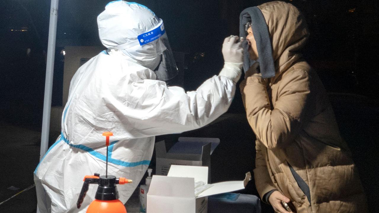 A medical worker conducting a Covid test in Xi’an on December 20. Picture: AFP