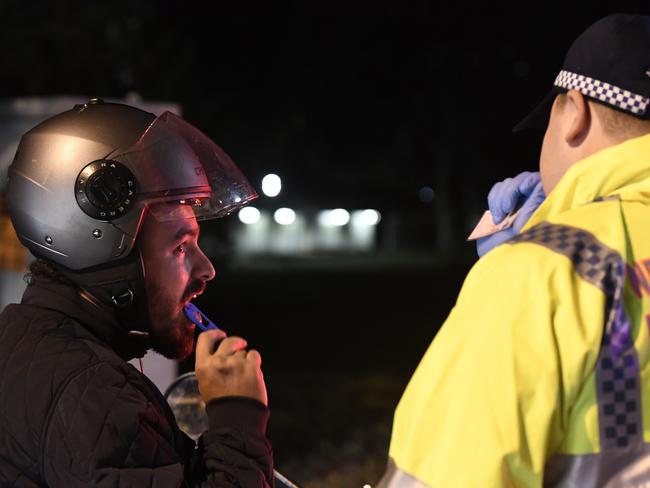 A motor scooter rider being tested at Ruhcutters Bay on Friday night. He did not test positive. Picture: Gordon McComiskie