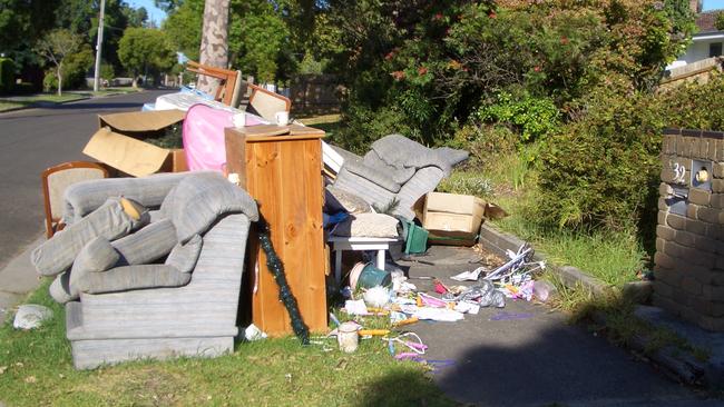 The mountain of trash has spread onto the footpath, creating a hazard for neighbours.