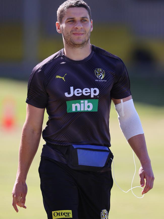 Dion Prestia walks laps at training with a antibiotic drip in his arm due to infection in ankle. Picture: Michael Klein