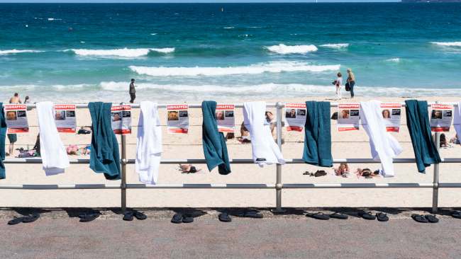An installation of beach towels and thongs along with posters showing those kidnapped in support of the Global #BringThemHome Campaign at Bondi Beach in Sydney. Picture: NCA NewsWire/Monique Harmer