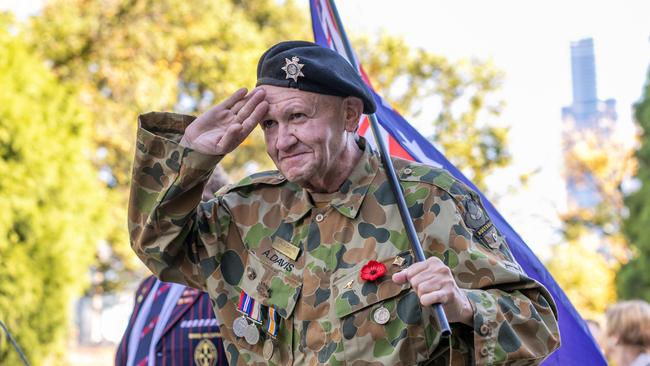 A man carrying the Australian flag salutes as he approaches the Shrine of Remembrance. Picture: Asanka Ratnayake/Getty Images