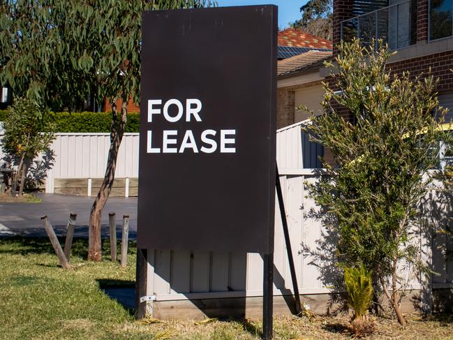 For lease sign on a blue display outside of a resedential building in Australia. Investment property real estate concept