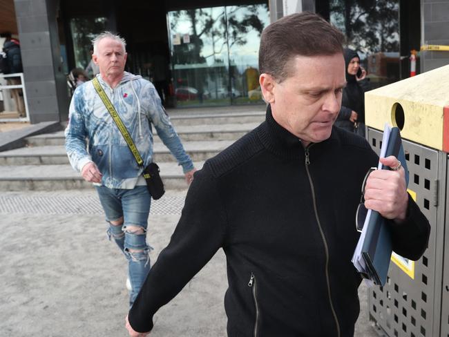 Pat Lennon (at rear) leaves the Broadmeadows Magistrate court with former jockey Danny Nikolic earlier this month. Picture: David Crosling