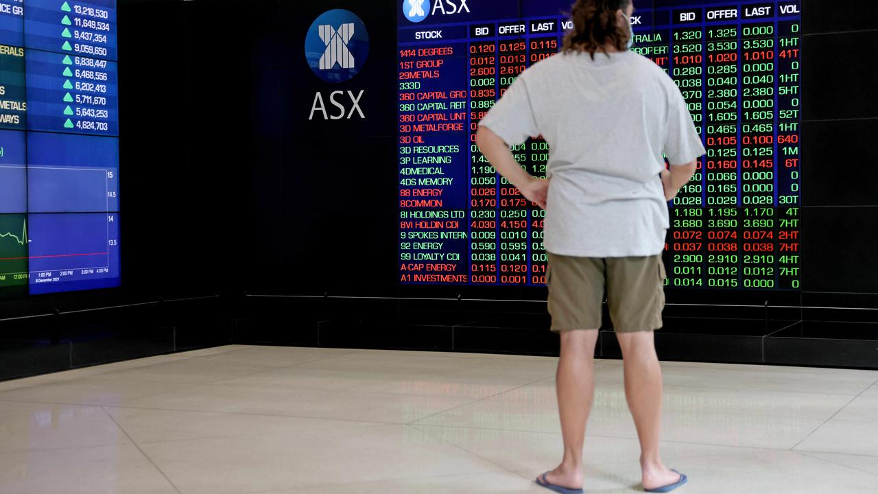 Doesn’t get more Aussie: a Sydney man with a mullet in thongs checking out that sweet ASX action. Picture: NCA NewsWire / Damian Shaw