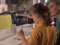 A Kids Hope Australia mentor works with a young student. Supplied