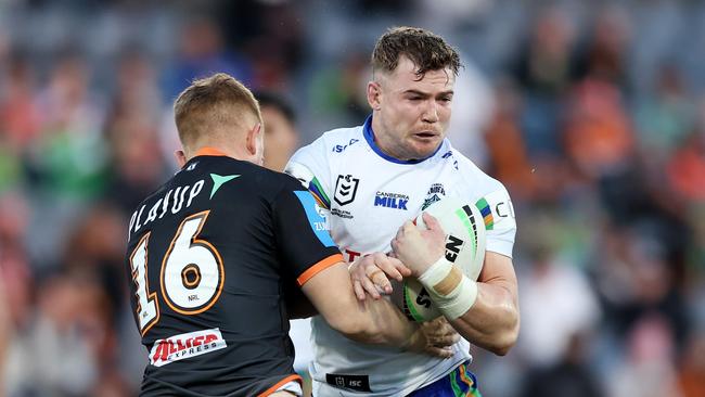 SYDNEY, AUSTRALIA - JUNE 23: Hudson Young of the Raiders is tackled during the round 16 NRL match between Wests Tigers and Canberra Raiders at Campbelltown Stadium, on June 23, 2024, in Sydney, Australia. (Photo by Matt King/Getty Images)