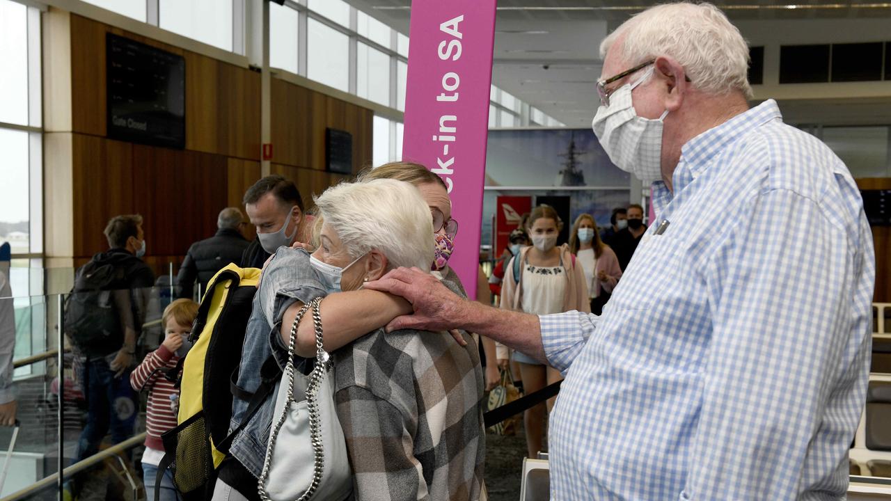 Anna Cock is reunited with her parents Jenny and Leon at Adelaide Airport. Picture: Naomi Jellicoe